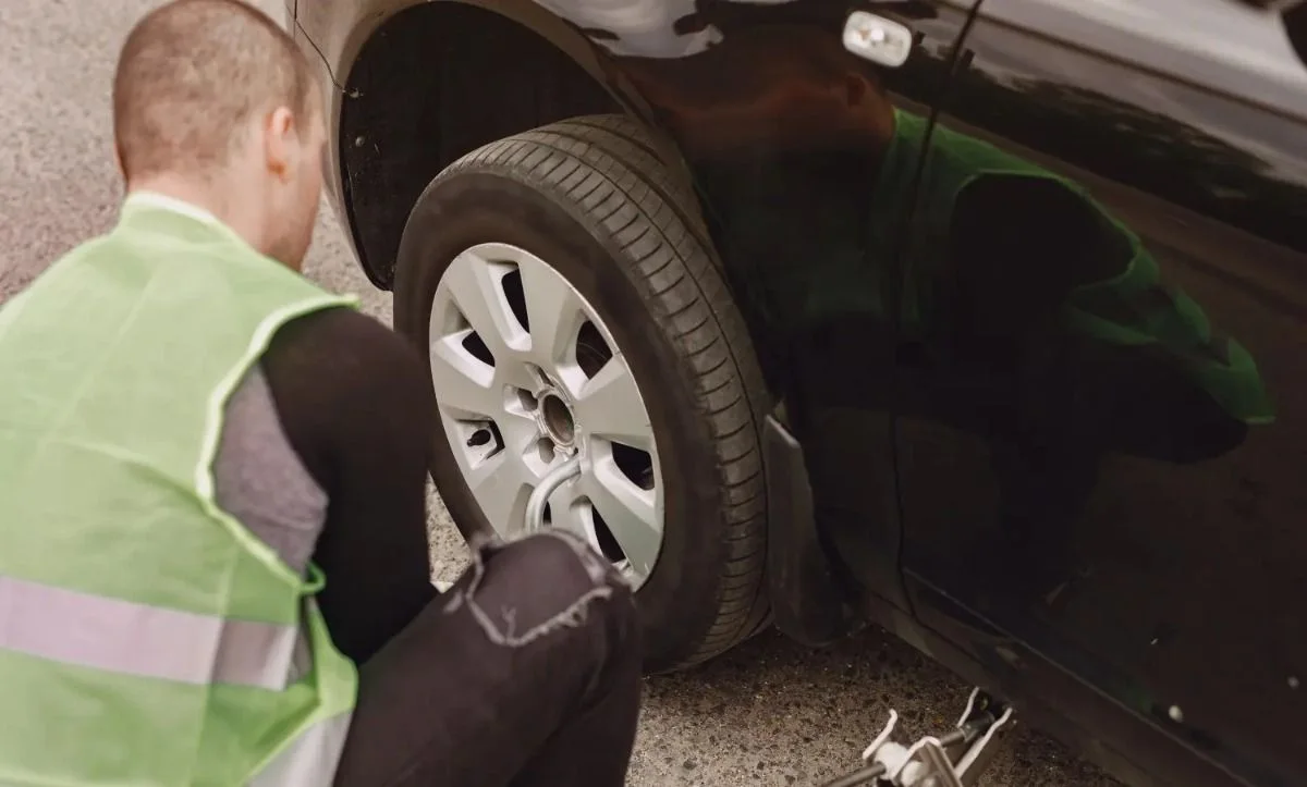 Flat car tyre being assessed for repair or replacement in Dubai